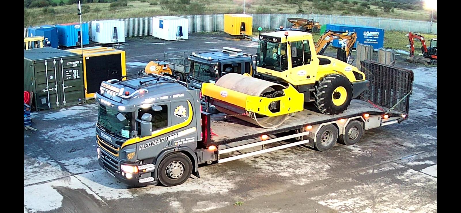 Truck transporting road rollers