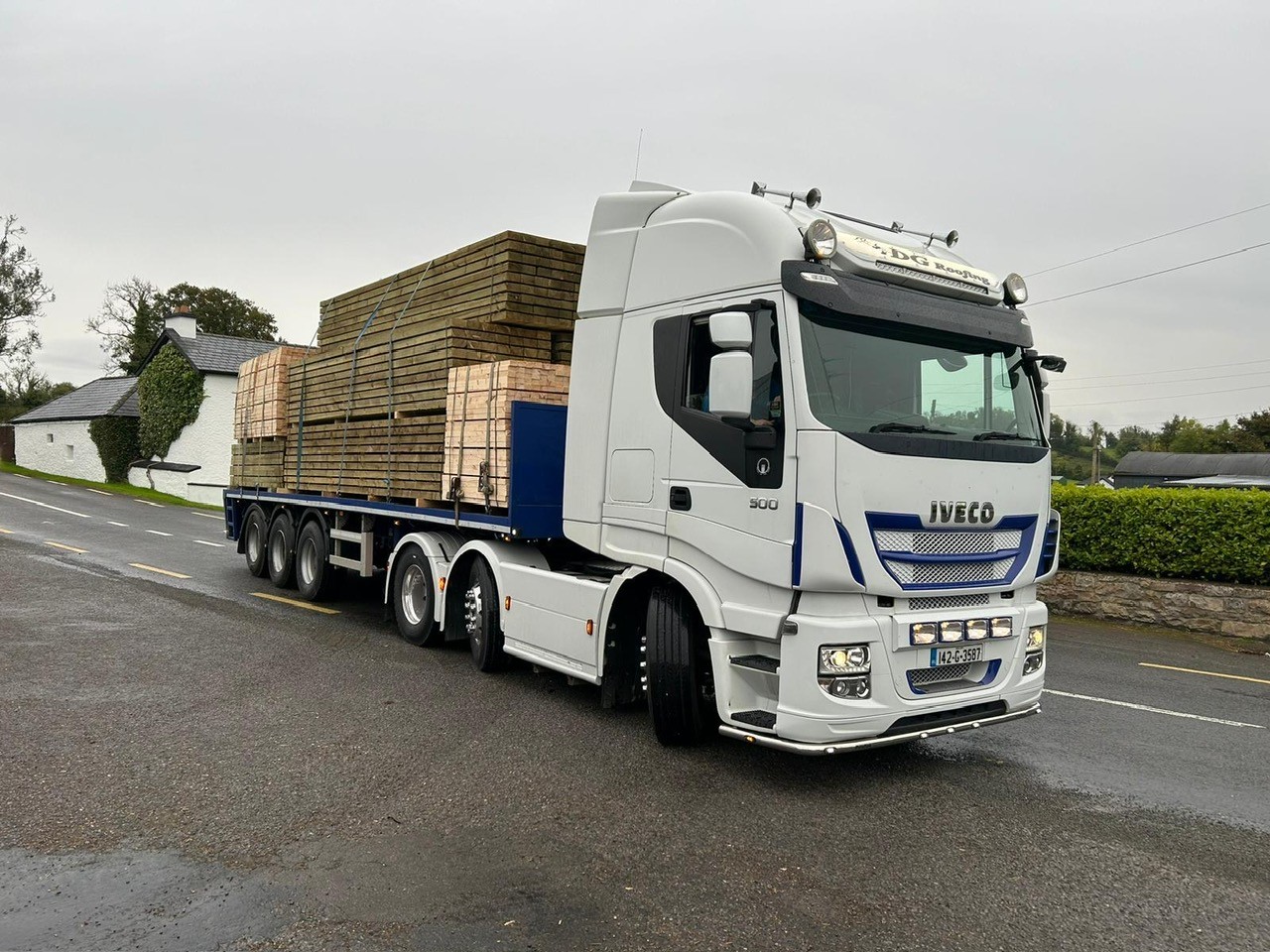 White Iveco truck transporting timber