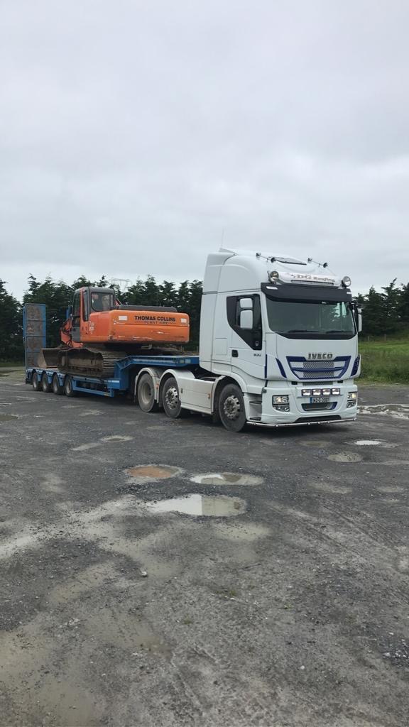 White Iveco with a loaded trailer