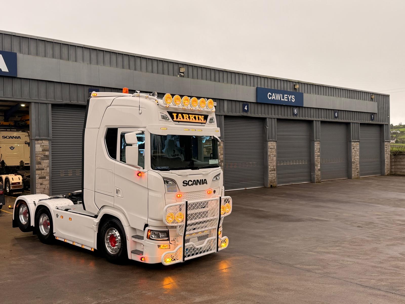 White Scania outside a workshop